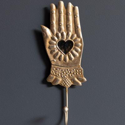 Hand with crochet and ex-voto heart mirror